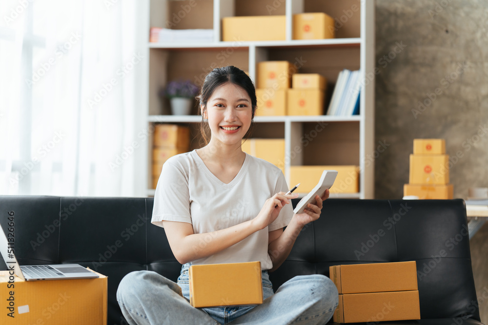 Starting small businesses SME owners female entrepreneurs check online orders to prepare to pack the boxes, sell to customers, sme business ideas online. Starting small businesses SME owners female entrepreneurs check online orders to prepare to pack the boxes, sell to customers, sme business ideas online.