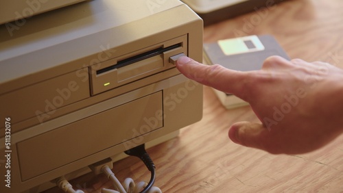 Hand inserting and ejecting Floppy Disk into vintage 80s PC
