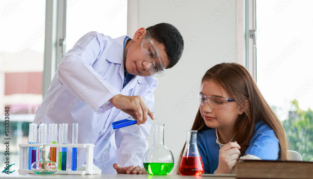 male and female students Have fun mixing colorful liquids in a glass tube male and female students Have fun mixing colorful liquids in a glass tube