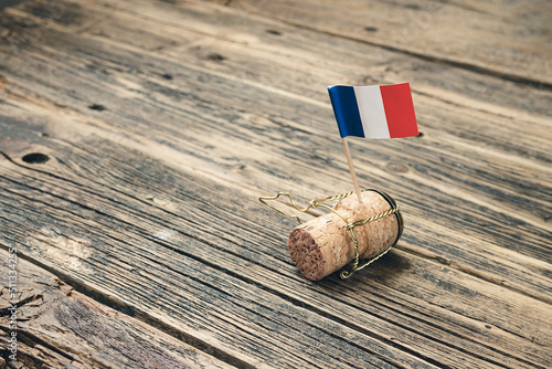 Champagne bottle cork with French flag on an old wooden table, Bastille Day and French National Day 14 July concept photo