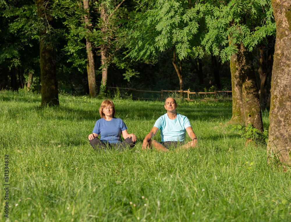 Having healthy lifestyle together of senior couple with sun rays on their faces sorrounded by nature Having healthy lifestyle together of senior couple with sun rays on their faces sorrounded by nature