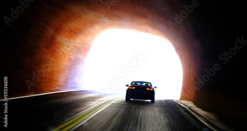 Car Driving Through Tunnel and Entering Light of Freedom photo