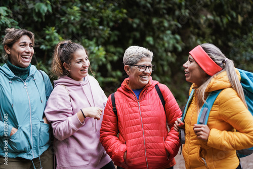 Multiracial women having fun together during trekking day at mountain forest
