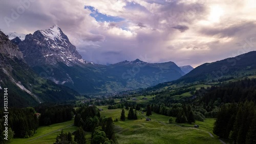 dramatic hyperlapse of incoming cumulonimbus cloud over Grindelwald in the Swiss Alps photo