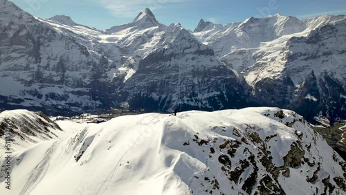 Aerial drone selfie shot of a snowboarder on a snowy mountain top in Switzerland photo