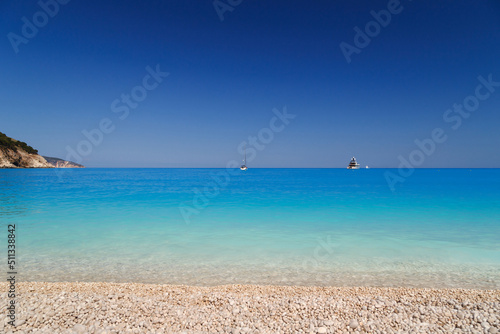 Fototapeta Naklejka Na Ścianę i Meble -  Fantastic view at Myrtos Beach with turquoise and blue Ionian Sea water. Summer scenery of famous and extremely popular travel destination in Cephalonia, Greece, Europe.