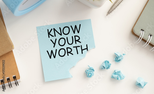 Know Your Worth text on a card on a clip on a notebook, a business concept