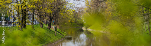 Wallpaper Mural River near grass and trees on street in Wroclaw, banner Torontodigital.ca