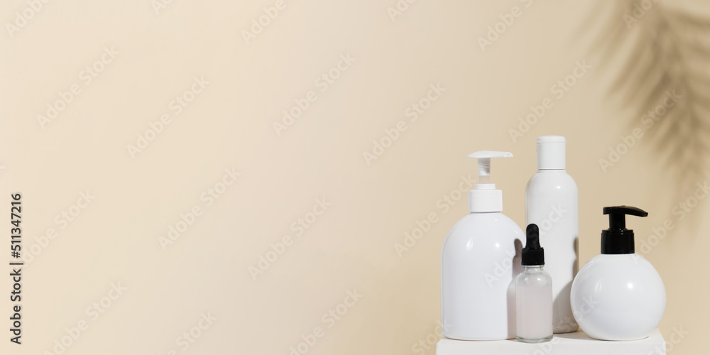 Set of natural cosmetic products on beige background with shadow of palm leaves. Copy space Set of natural cosmetic products on beige background with shadow of palm leaves. Copy space