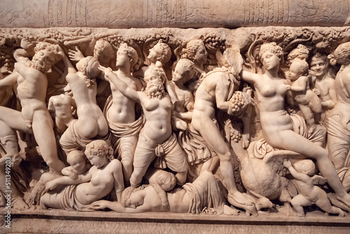 Bas-relief on the sarcophagus depicting a bacchanal led by the god of fun and wine - Dionysus photo