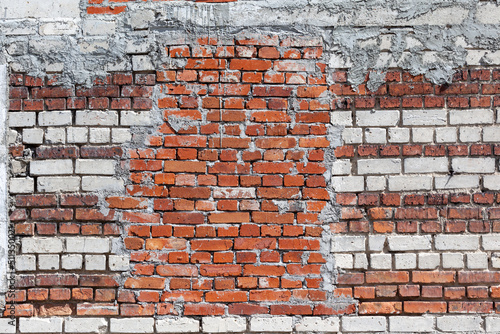 Red brick wall, old brick, grunge texture background. A wall with a walled-up window opening.