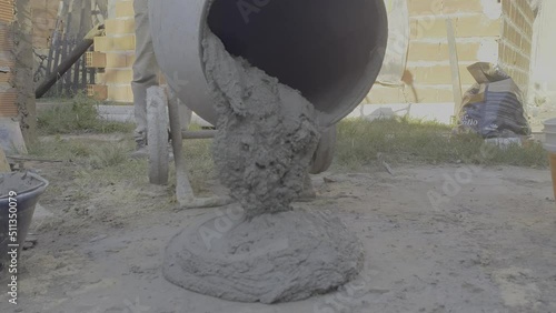 Dumping the prepared and ready material of the concrete mixer on the floor