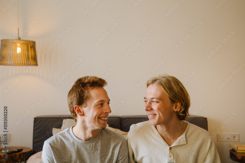 Young gay couple laughing and looking at each other Young gay couple laughing and looking at each other