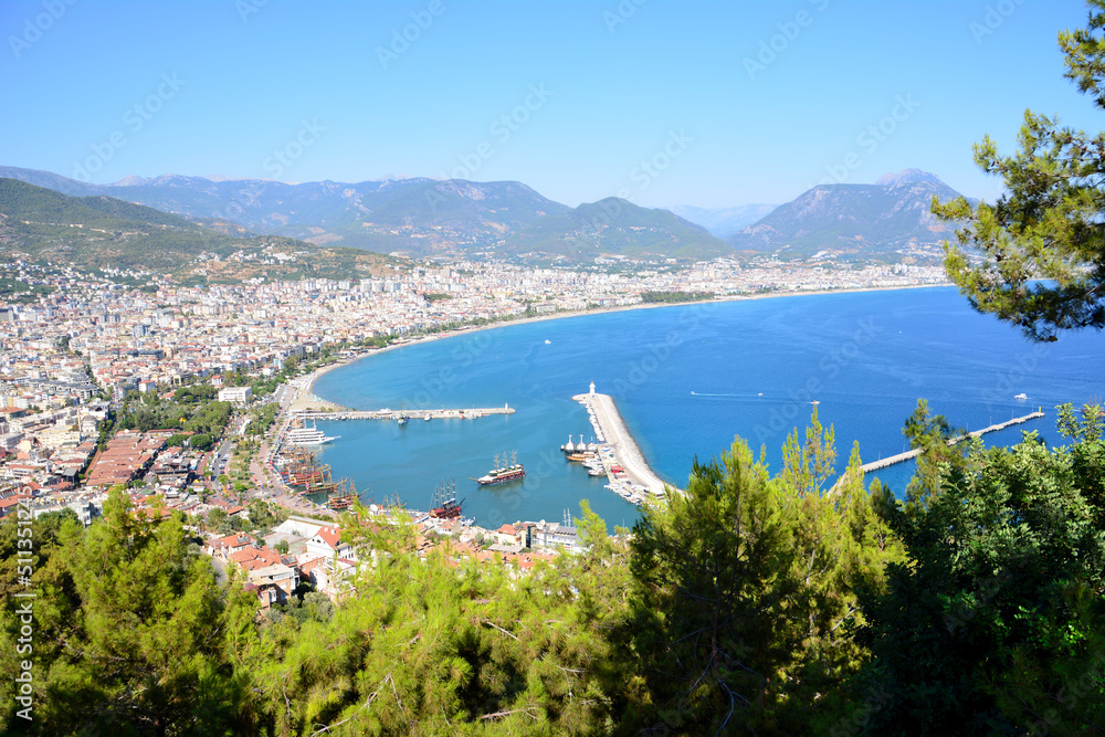 turkish town with lighthouse, seaport and waterfront, view from top of mountain