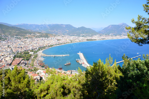 turkish town with lighthouse, seaport and waterfront, view from top of mountain