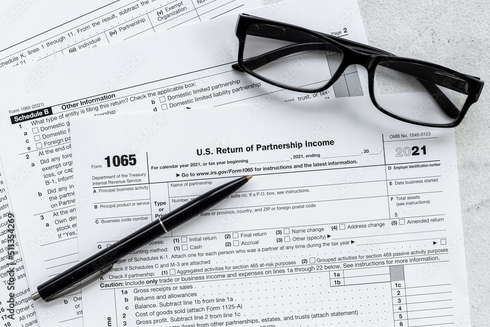 Businessman table with US tax form and pen. Culculating and payment of taxes Businessman table with US tax form and pen. Culculating and payment of taxes