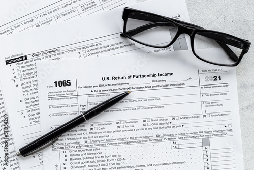Businessman table with US tax form and pen. Culculating and payment of taxes