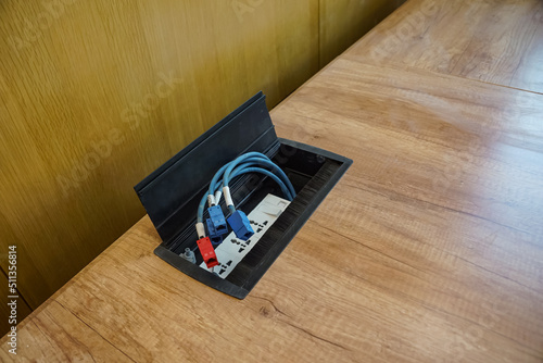 Female LAN connectors on the wooden table. LAN cables on the table.