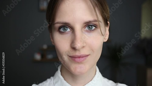 The girl slowly lifts her head and looks at the camera