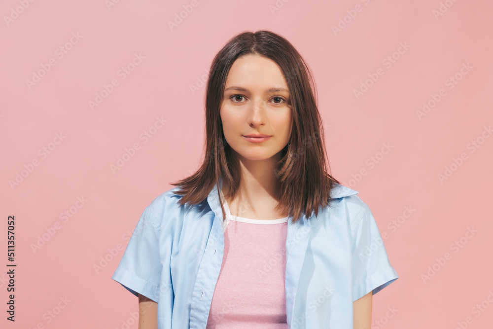 Young beautiful girl wearing top and summer shirt looking at camera isolated on pink background. Concept of emotions, facial expression, youth Young beautiful girl wearing top and summer shirt looking at camera isolated on pink background. Concept of emotions, facial expression, youth