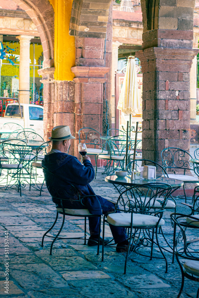 Naklejka premium Man having a glass of wine alone in a Mexican town