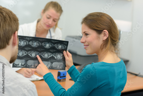 young female reviewing brain xrays with husband