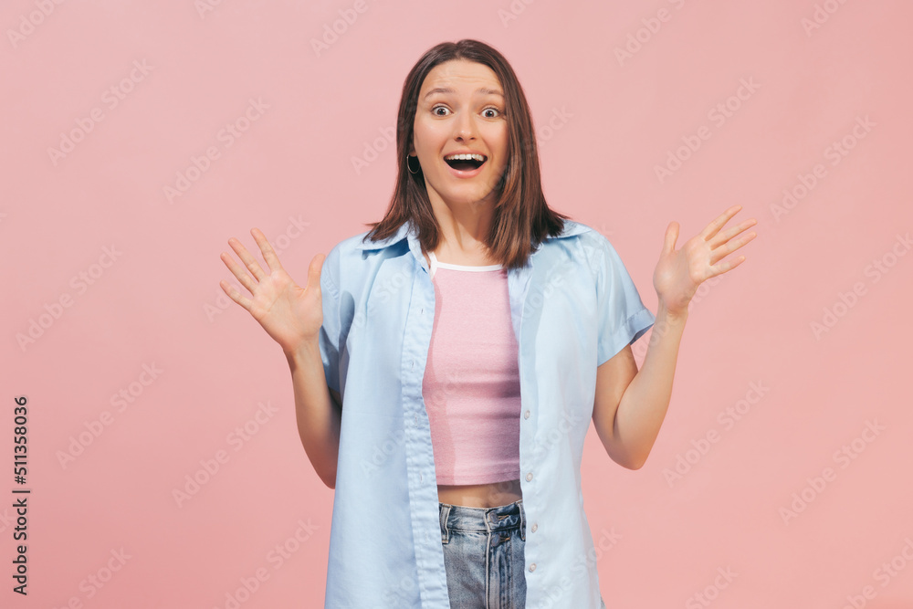 Excited young beautiful girl wearing top and summer shirt looking at camera isolated on pink background. Concept of emotions, facial expression, youth Excited young beautiful girl wearing top and summer shirt looking at camera isolated on pink background. Concept of emotions, facial expression, youth