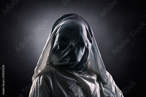 Portrait of a scary ghost over dark misty background