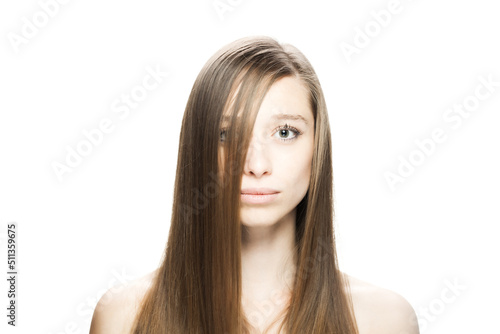 Studio portrait of a beautiful brunette girl with positive face expression looking at camera...