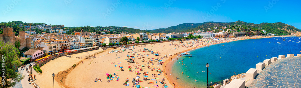  A crowd of vacationers enjoy the warm beaches of Costa Brava. Tossa de Mar, Spain.