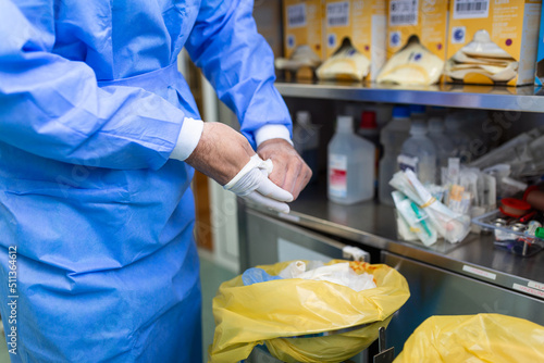 Εκτύπωση καμβά Male surgeon removing surgical gloves in operation theater at hospital