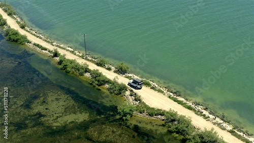 Aerial view of an offroad vehicle on an expedition through a lagoon (Amvrakikos Wetlands National Park) photo