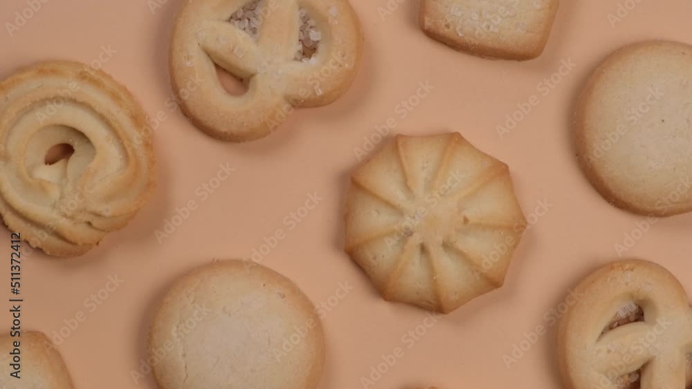 background of spinning cookies on a beige or peach background, food trendy background in pastel colors background of spinning cookies on a beige or peach background, food trendy background in pastel colors