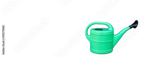 Green plastic sprinkling can outdoor in garden. Watering can.