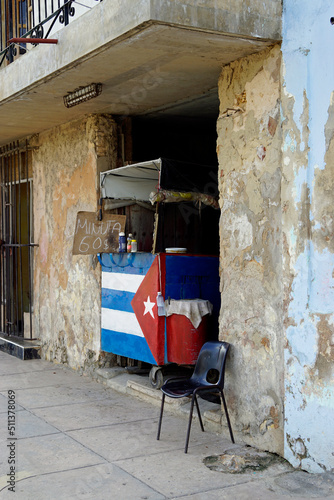 Photography small food shop in the streets of Cardenas with cuban flag