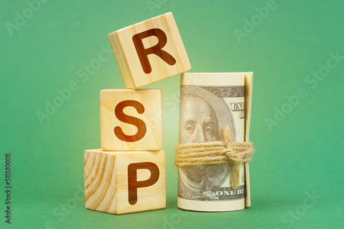 On a green surface, dollars and cubes with the inscription - RSP