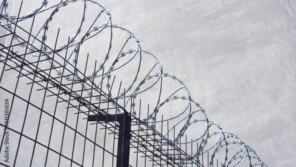 Concertina barb wire, heavy duty, metal fence. A prison, crime concept
