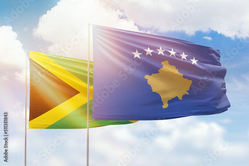 Sunny blue sky and flags of kosovo and jamaica