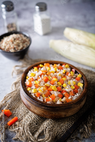 Corn red bell pepper black and white and brown rice in a bowl