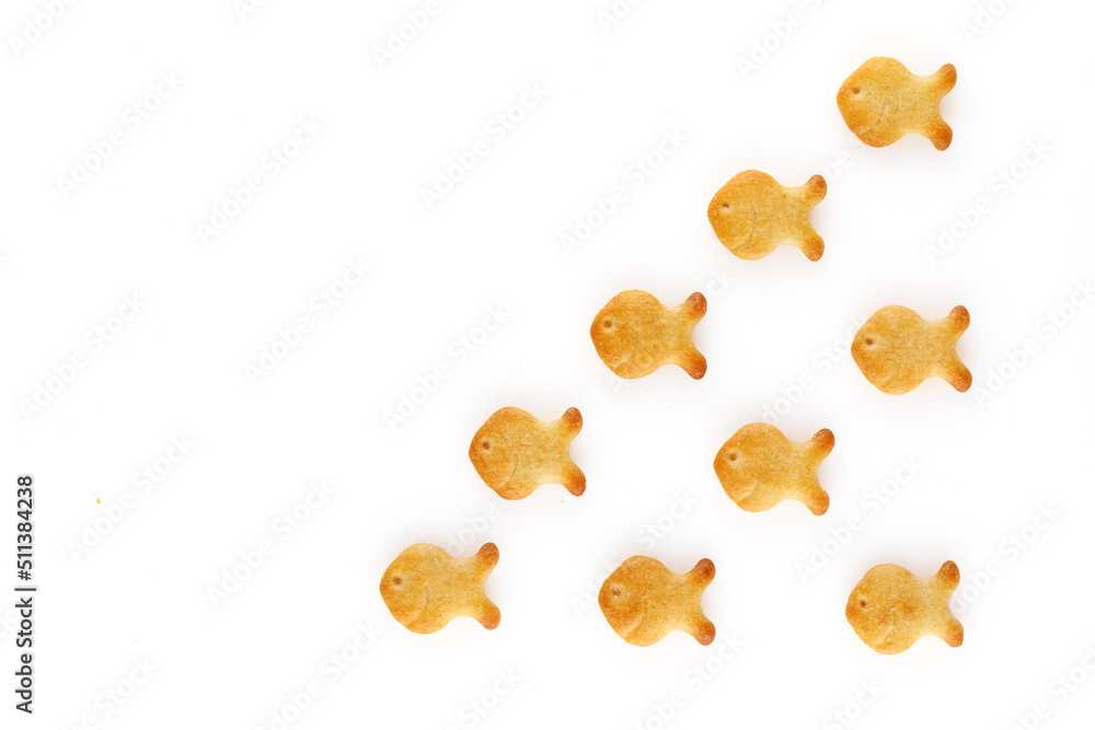 Yellow fish crackers on isolated white background. Close-up. Yellow fish crackers on isolated white background. Close-up.