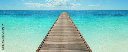 Wooden jetty in the turquoise indian ocean. way to vacation.