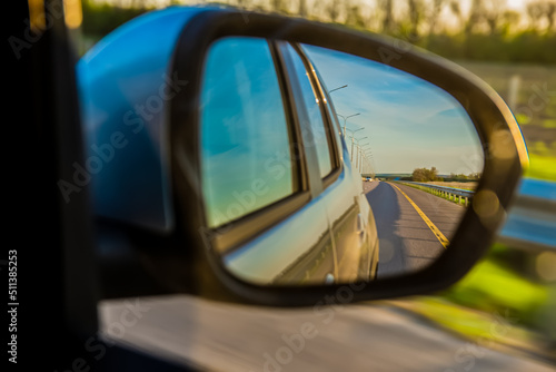 The road is reflected in the side mirror of the car © Андрей Глущенко
