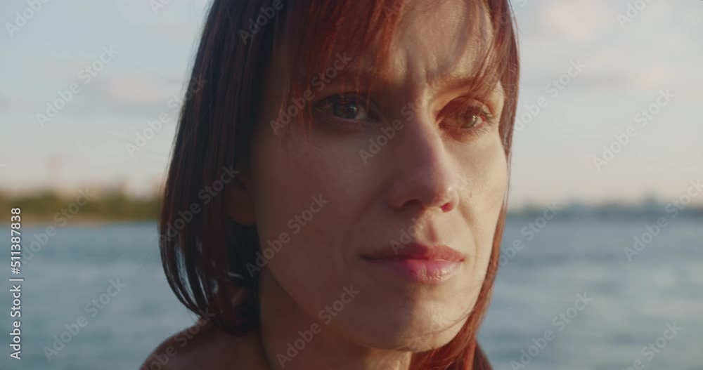 Woman contemplation of sea bay at evening in city. Close up Woman contemplation of sea bay at evening in city. Close up