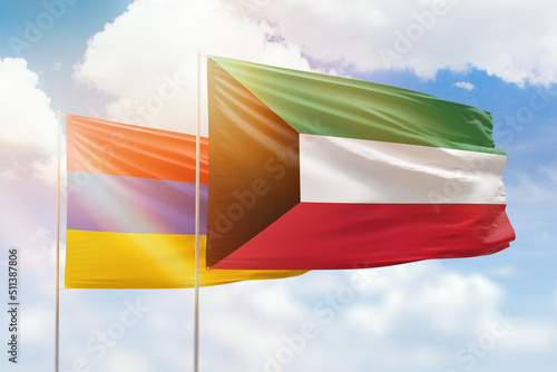 Sunny blue sky and flags of kuwait and armenia