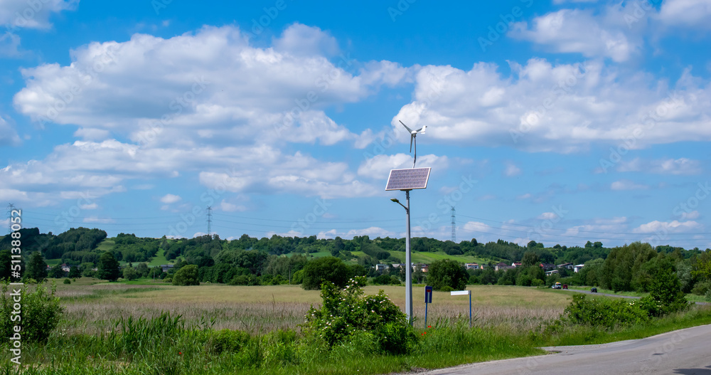 Fototapeta premium renewable energy lighting pole, solar panel and wind turbine