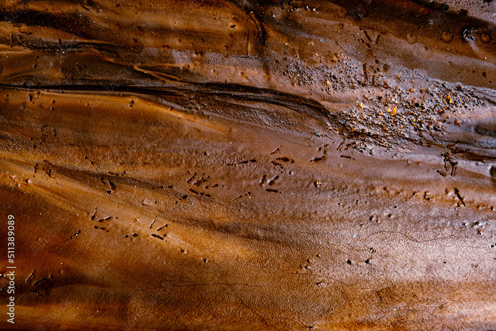 Naklejka premium colored mud river, close view