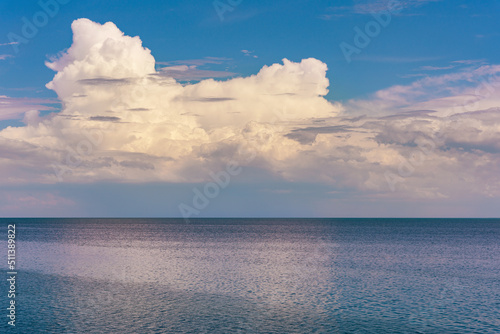 Seascape calm blue sea and sky with clouds