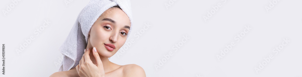 Beautiful girl with thick eyebrows and perfect skin at white background, towel on head, beauty photo. Beautiful girl with thick eyebrows and perfect skin at white background, towel on head, beauty photo.