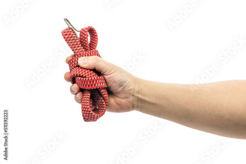 Hand holding a bundle of red rubber elastic tied rope closeup isolated on white background