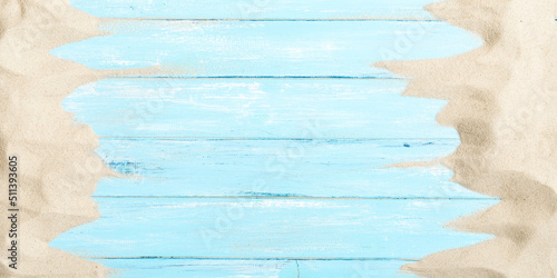 Sand on blue planked wood. Summer background. Flat lay, top view, copy space